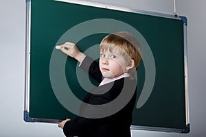 Little funny boy with blackboard