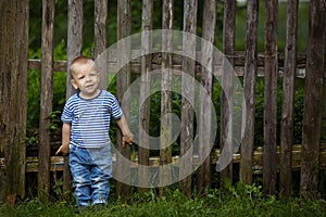 Little funny boy with fence