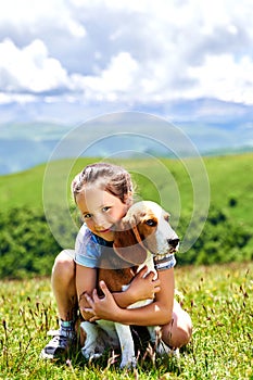 little funny girl with a dog in the mountains