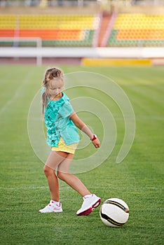 Little funny girl on football stadium