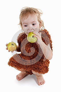 Little funny Neanderthal boy in a suit with dirty face eating an apple.