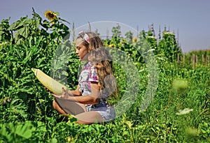 Little gardener girl working at farm, growing organic food