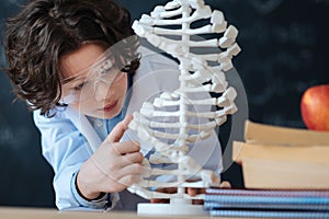 Little gifted researcher studying genetic code in the laboratory