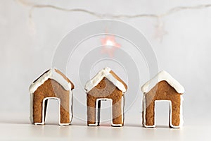 Little gingerbread houses and garland on background. Christmas baking