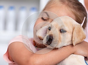 Little gir hugging her new puppy she just got