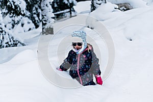 Little girl of 3 yo playing in the snow