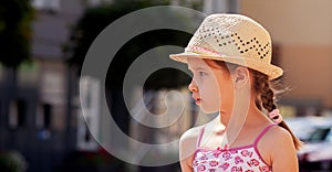 Little girl alone, school age child model looking right, copy space, text space on left, caucasian kid wearing panama hat, summer