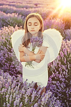 Little girl with angel wings and white dress