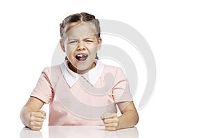 The little girl is angry and screaming. Isolated over white background