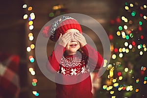 Little girl in anticipation of a Christmas miracle and a gift photo