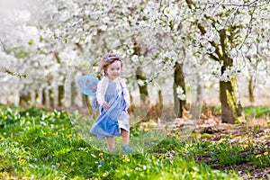 Little girl in apple tree garden