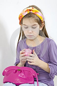 Little girl applying make-up with powder-puff