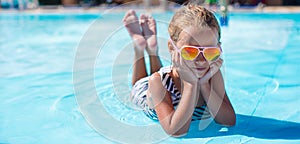 Little girl at aquapark during summer vacation