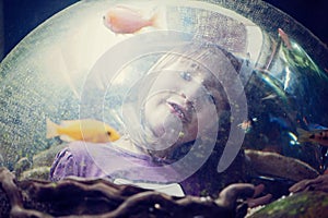 Little girl in the aquarium