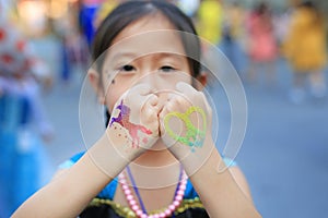 Little girl with arm painted for the party. Body art. Selected focus at his hand