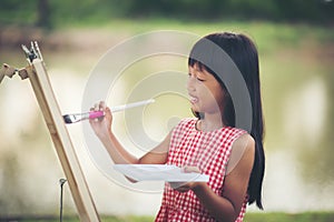 Little girl artist painting picture