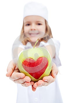 Little girl as nurse giving you an apple