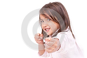 Little girl assuming stance, practicing martial arts