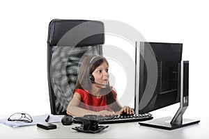 Little girl with astonishment looks in the compute