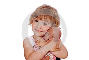 Little girl with baby doll toy