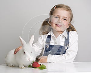 Little girl and baby rabbit