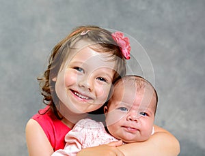 Little girl and baby- sister photo