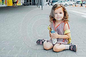 Little girl with backpack and baby bottle travel in the airport or railway station, kids travel