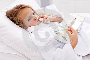 Little girl with bad cold - using nasal spray