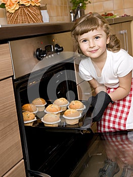 Little girl baking muffins