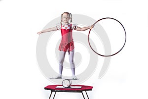 Little girl balancing act on white background.