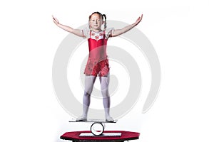 Little girl balancing act on white background.