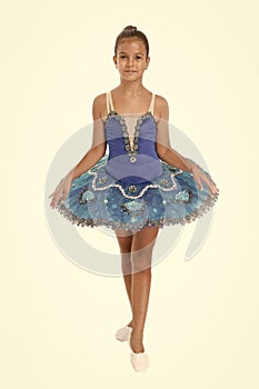 Little girl in ballet position. Little ballerina in blue tutu. Adorable ballerina girl take dance lesson. Dancing queen