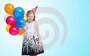 Little girl with balloons on blue background