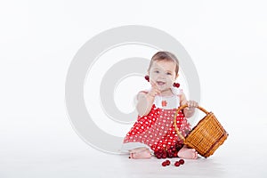 Little girl with a basket of cherries berries