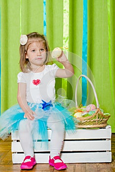 Little girl with a basket with Easter eggs