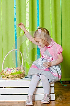 Little girl with basket with Easter eggs