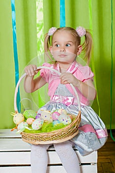 Little girl with basket with Easter eggs