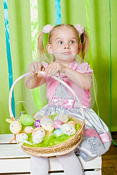 Little girl with basket with Easter eggs