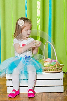 Little girl with basket with Easter eggs