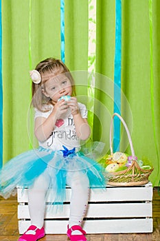 Little girl with basket with Easter eggs
