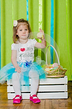 Little girl with basket with Easter eggs