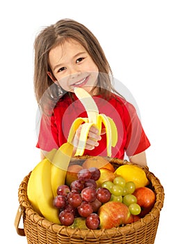 Little girl with basket of fruits