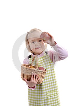 Little girl with basket full of apples