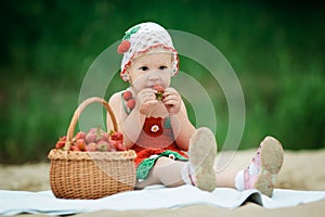 Little girl with basket full of strawberries