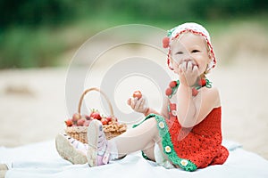 Little girl with basket full of strawberries