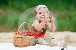 Little girl with basket full of strawberries