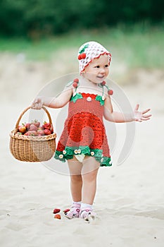 Little girl with basket full of strawberries