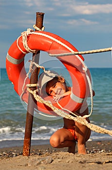 Little girl in bathing suit standing on beach