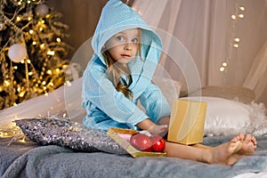 Little girl in bathrobe. Christmas