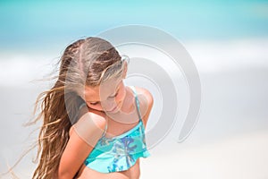 Little girl at beach during caribbean vacation. Portrait of beautiful kid background blue sky